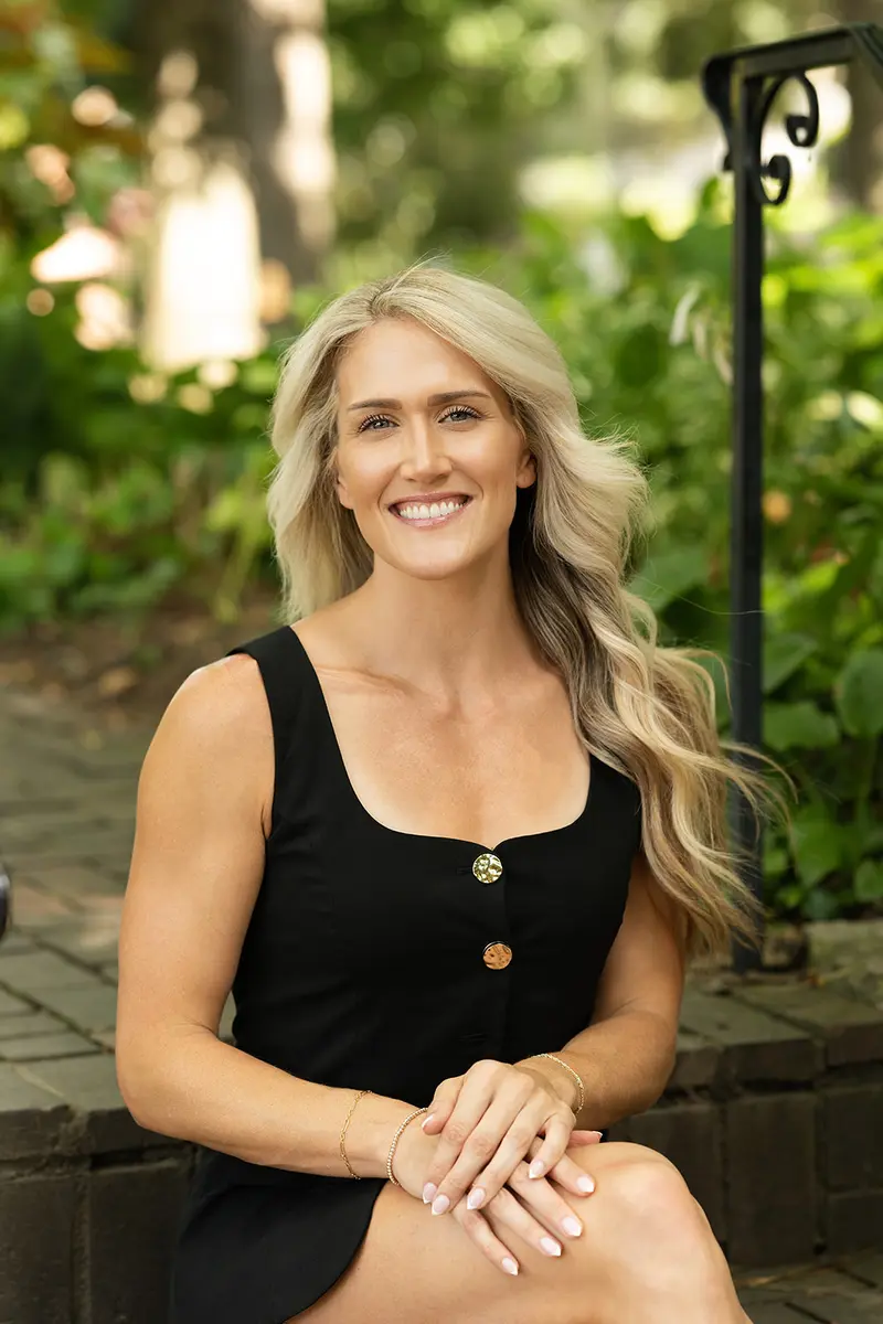 Lauren Wessel smiling in a leafy Cincinnati neighborhood setting
